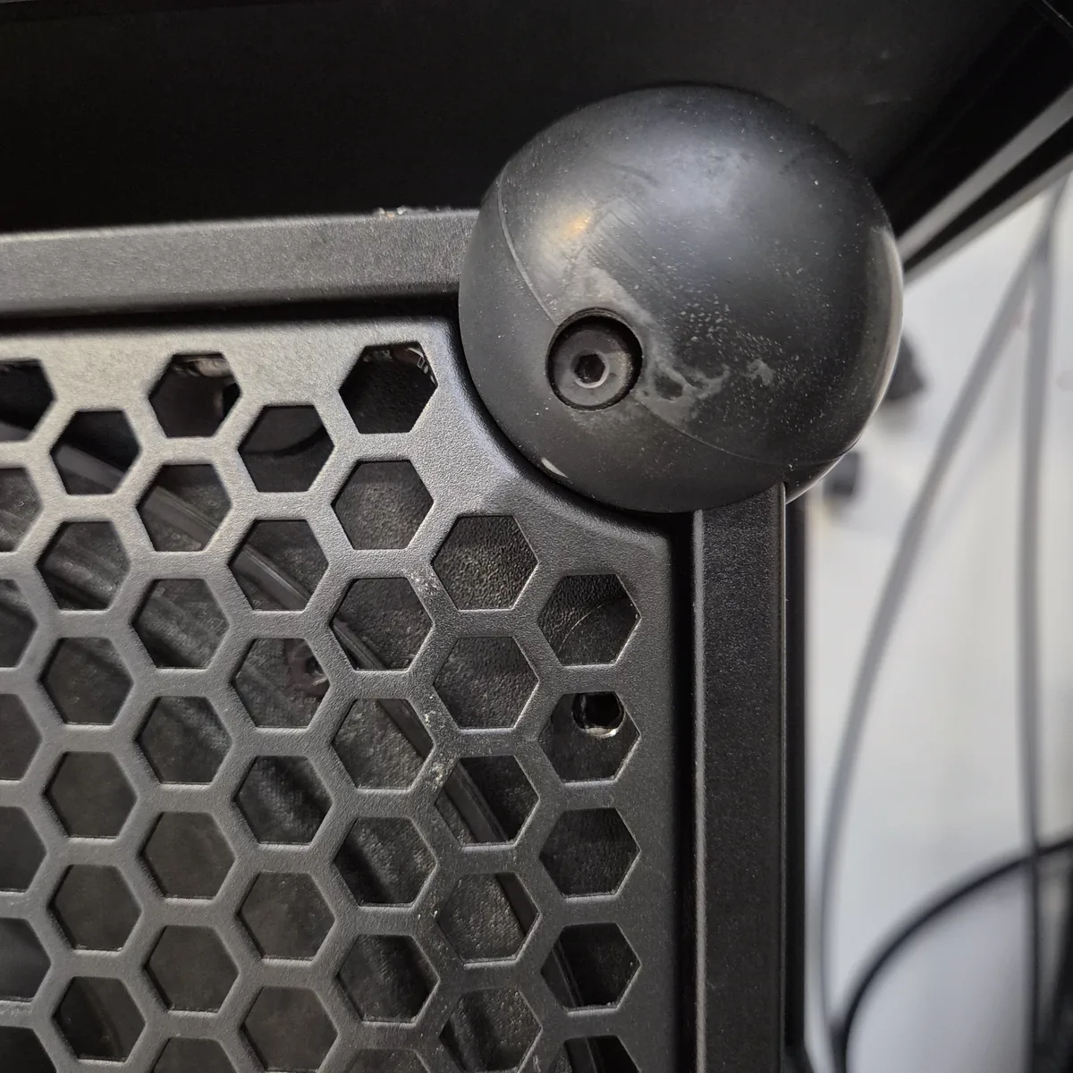 Close-up of the front grill on a Soundboks 3 with large, coarse hexagons